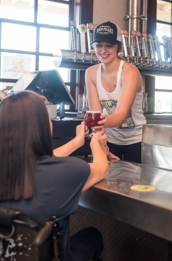 Bartender Serving a Cold Glass of Beer Bartender Serving a Cold Glass of Beer