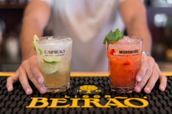 Bartender Serving Two Flavored Cocktails Bartender Serving Two Flavored Cocktails