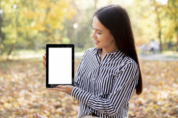 Beautiful woman holding a tablet with mock-up Free Photo