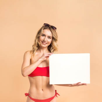 Beautiful woman in red swimsuit showing blank paper Free Photo