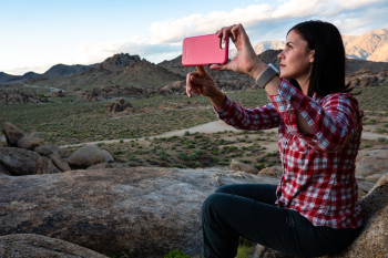 Beautiful woman/wife taking selfie with iPhone while hiking in the rocks of Alabama Hills, Ca. I love watching my wife take photos of herself .