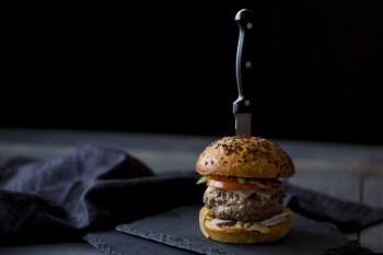 Beef burger slider with knife in it Beef burger slider with knife in it