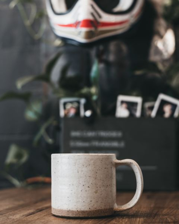 beige and gray mug on brown tabletop beige and gray mug on brown tabletop