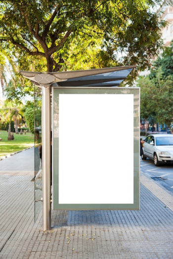 Billboard at bus stop in front of trees