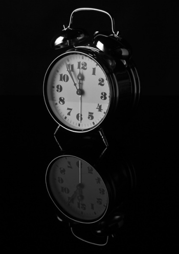 Black Alarm Clock Displaying 12:55 Black Alarm Clock Displaying 12:55