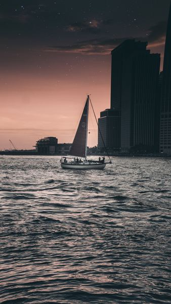 black and gray sailboat on body of water black and gray sailboat on body of water