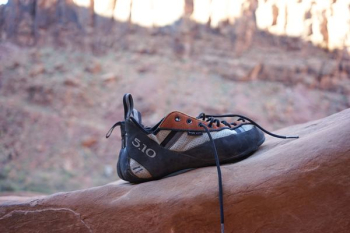 black and white shoes place on rock formation black and white shoes place on rock formation