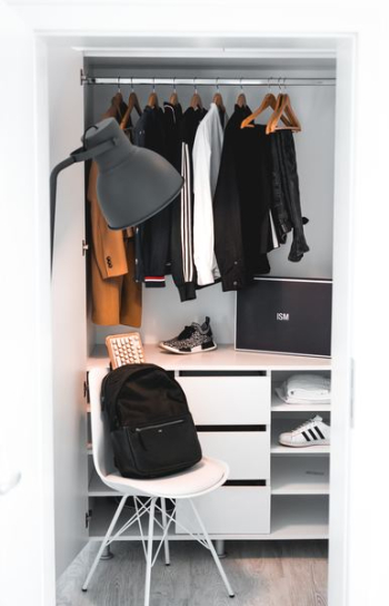 black backpack on white chair beside cabinet black backpack on white chair beside cabinet