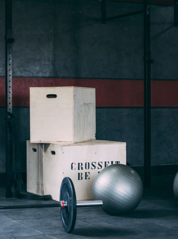 black barbell near gray exercise ball on floor