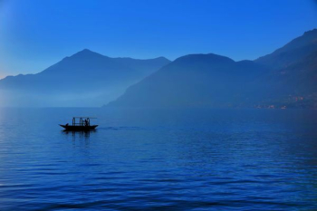 black boat in body of water black boat in body of water