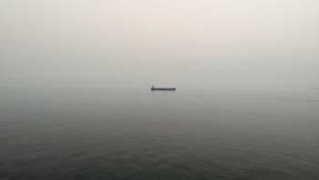 black boat on body of water black boat on body of water
