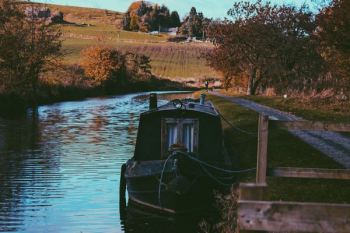 black boat on body of water black boat on body of water
