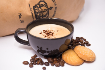 Black Ceramic Coffee Mug Surrounded By Coffee Beans