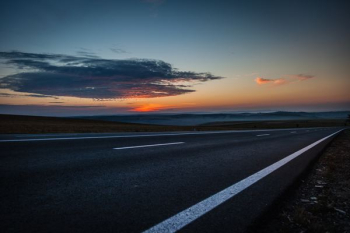 black concrete road during sunset black concrete road during sunset