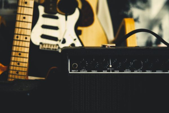 black guitar amplifier beside electric guitar black guitar amplifier beside electric guitar
