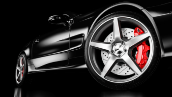 Black luxury car in studio lighting. Closeup wheel shot. 3d render