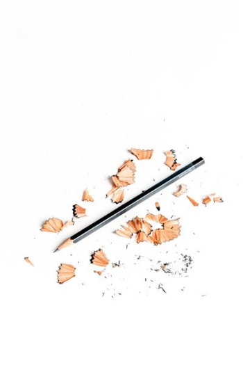 black pencil surrounded by pencil husk black pencil surrounded by pencil husk