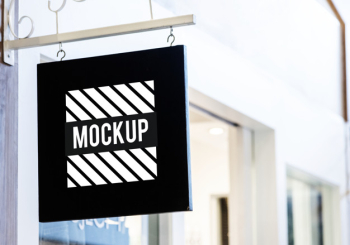 Black sign mockup outside a shop Free Psd