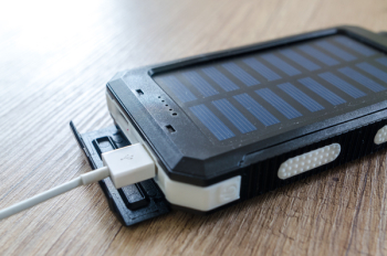 Black Solar Power Bank on Brown Surface Black Solar Power Bank on Brown Surface