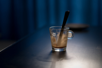 Black Stirring Rod on Clear Glass Cup Black Stirring Rod on Clear Glass Cup