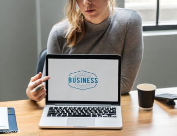 Blond woman pointing at a laptop screen | Free stock psd mockup - 414308