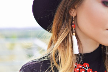 blonde haired woman in white tassel dangling earring blonde haired woman in white tassel dangling earring