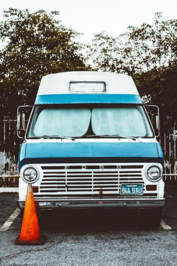 blue and white Ford car beside orange traffic cone blue and white Ford car beside orange traffic cone