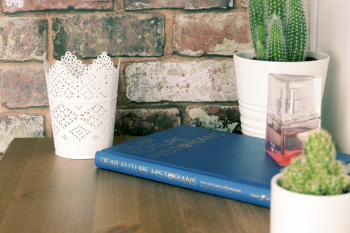 Blue Book on Brown Wooden Table with flower vases
