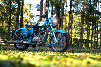 Blue Motorcycle on Green Grass Blue Motorcycle on Green Grass