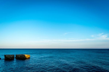 blue ocean water under blue sky blue ocean water under blue sky