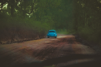 Blue Volkswagen Beetle on a Country Road Blue Volkswagen Beetle on a Country Road