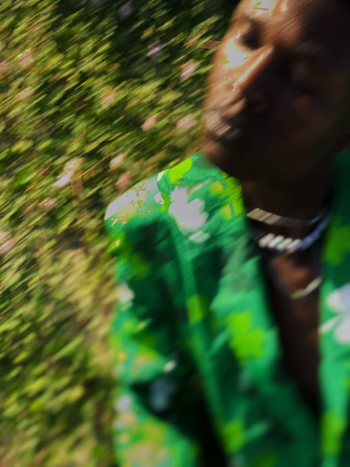 Blurry Picture of a Man in a Green Suit