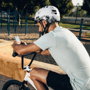 Bmx rider cheking out his phone medium shot Free Photo