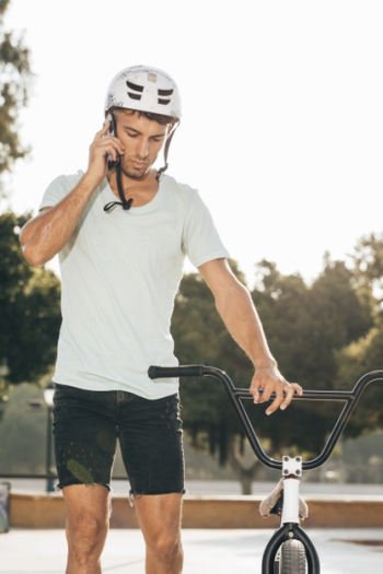 Bmx rider talking at the phone Free Photo