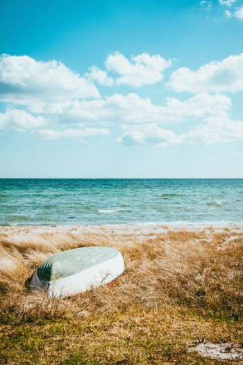 boat on beach under blue sky boat on beach under blue sky