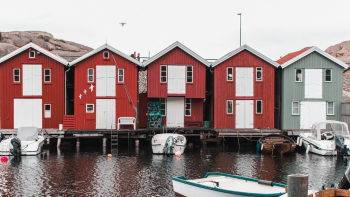Boats Anchored On A Marina Bay With Houses