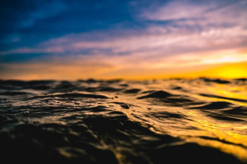 body of water at sunset body of water at sunset
