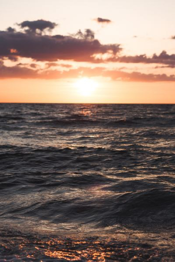 body of water over sunset body of water over sunset