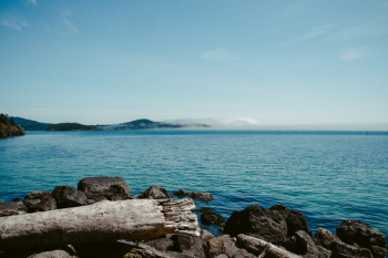 body of water under blue sky body of water under blue sky