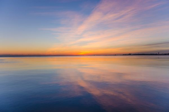 body of water under cloudy sky body of water under cloudy sky