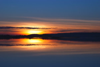 body of water under sunset body of water under sunset
