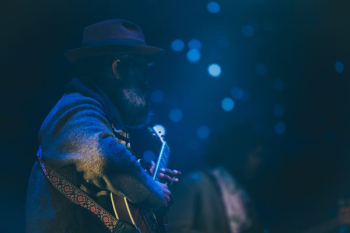 bokeh shot of man playing guitar bokeh shot of man playing guitar