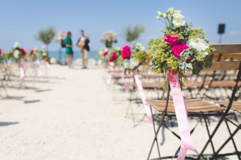 bouquet of flower attach to chair bouquet of flower attach to chair