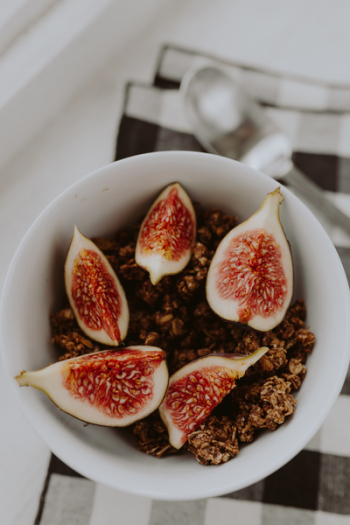 Bowl of crunchy granola and figs Bowl of crunchy granola and figs