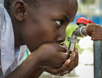Boy Drinking Water on Faucet Boy Drinking Water on Faucet