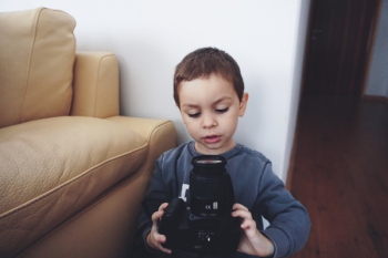Boy Holding Black Dslr Camera Boy Holding Black Dslr Camera