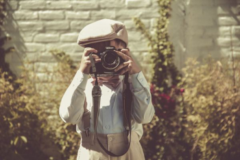 boy holding black DSLR camera