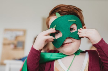 boy holding green mask boy holding green mask
