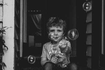 Boy Playing Bubbles Boy Playing Bubbles