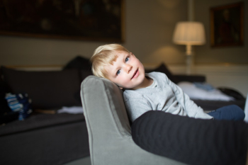 Boy Seated on Sofa Boy Seated on Sofa